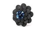 Dark wooden lapel pin with blue flower