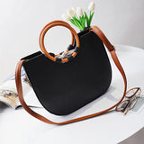 Knitted Handbag with wooden O-handle in black