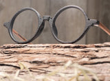 Wood glasses with circular black frame and brown arms