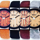 burnt orange, black, burgundy, and grey watch with wood face and vegan leather band